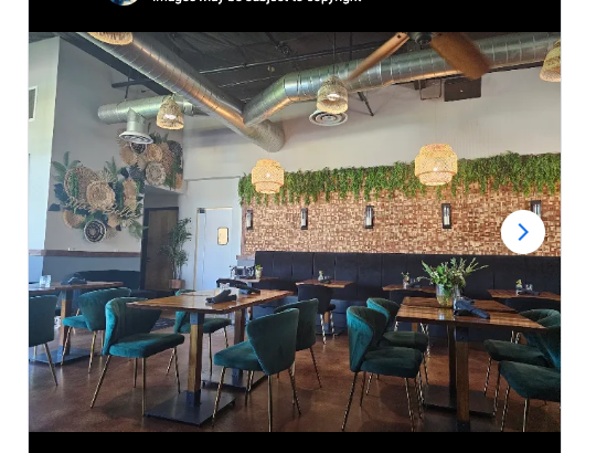Existing dining room with wooden tables, green chairs, dark booths and woven pendant lights